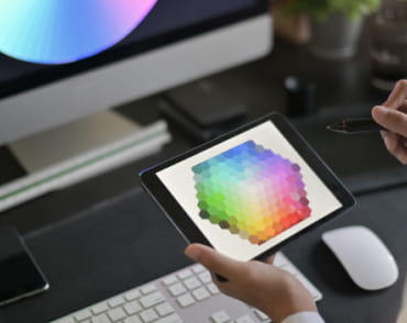 Девушка намеревается выбрать цвет из цветовой палитры, отображенной на экране планшета